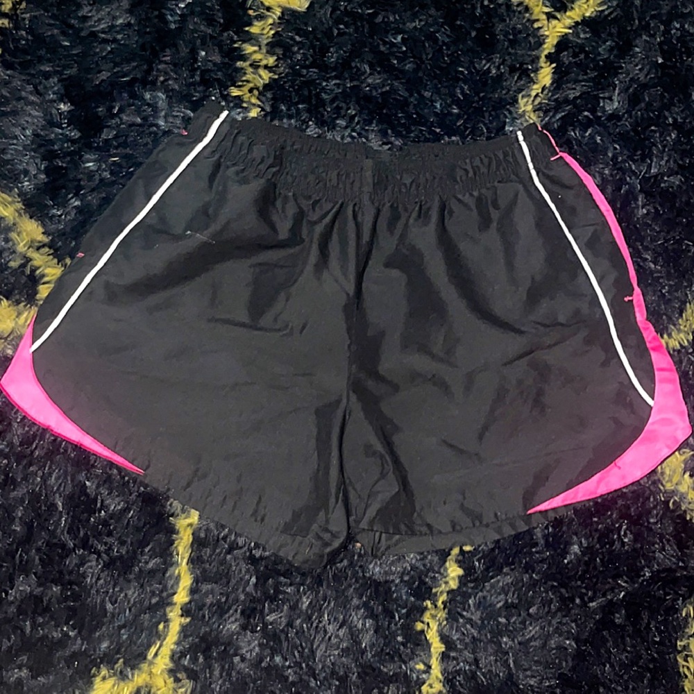 Women’s black athletic shorts with hot pink and white stripes